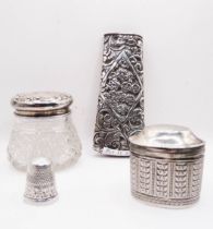 A small Dutch silver oval pill box with hinged lid and engraved repeat decoration - sold with a