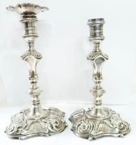 A pair of 20cm high antique English silver ornate heavy gauge candlesticks, one with original cast