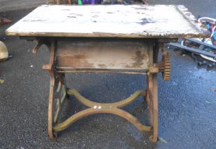 A vintage mangle table, set on a cast iron base