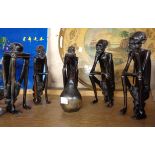 A group of five African carved ebony seated figures with central gourd style pot - some arm cracks