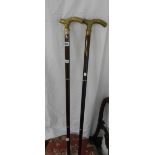 Two modern collapsible walking sticks with cast brass handles