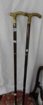 Two modern collapsible walking sticks with cast brass handles