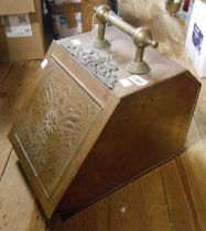 An old brass coal box with embossed panel lift-front