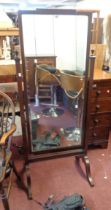 An early 20th Century stained walnut cheval mirror with bevelled plate, set on square supports and