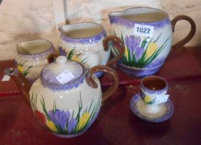 A set of three Longpark pottery Torquay graduated jugs decorated in the Crocus pattern - sold with a