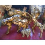 Six resin animal figurines comprising tiger, cheetah, elephant with calf and two giraffes, each