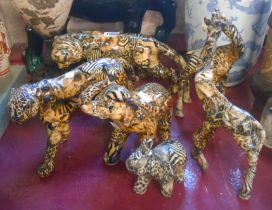 Six resin animal figurines comprising tiger, cheetah, elephant with calf and two giraffes, each