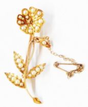 A marked 15ct. yellow metal flower pattern brooch, set with numerous seed pearls