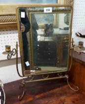A vintage brassed metal framed swing dressing table mirror with flanking candle sconces, set on