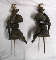 A pair of large spelter candlesticks tops of cherub form with brass sconces (bases missing)