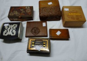 A box containing a quantity of small boxes including carved wood and metal examples