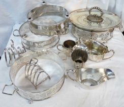 A box containing a quantity of silver plated items including dish sleeves, toast rack, etc.