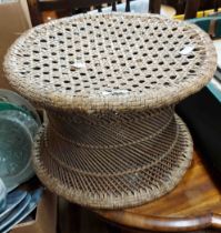 An old Eastern woven canework waisted drum shaped stool with carrying handle to side