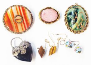 A bag containing a banded agate brooch, old gilt metal mourning brooch, two pendants and two pairs