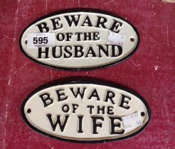 Two small modern painted cast iron signs 'Beware of the Husband' and 'Wife'