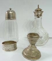 A silver topped cut glass sugar caster and silver topped cut glass oil bottle - sold with silver