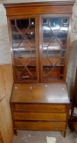 A 92cm Edwardian inlaid mahogany bureau/bookcase with adjustable shelves enclosed by a pair of