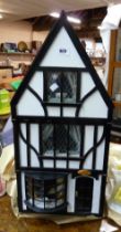 A small doll's house of antique shop form in the mock Tudor style with a large quantity of furniture
