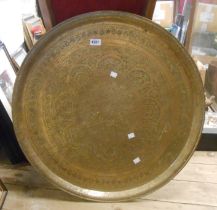 A large Eastern brass tray with chased decoration