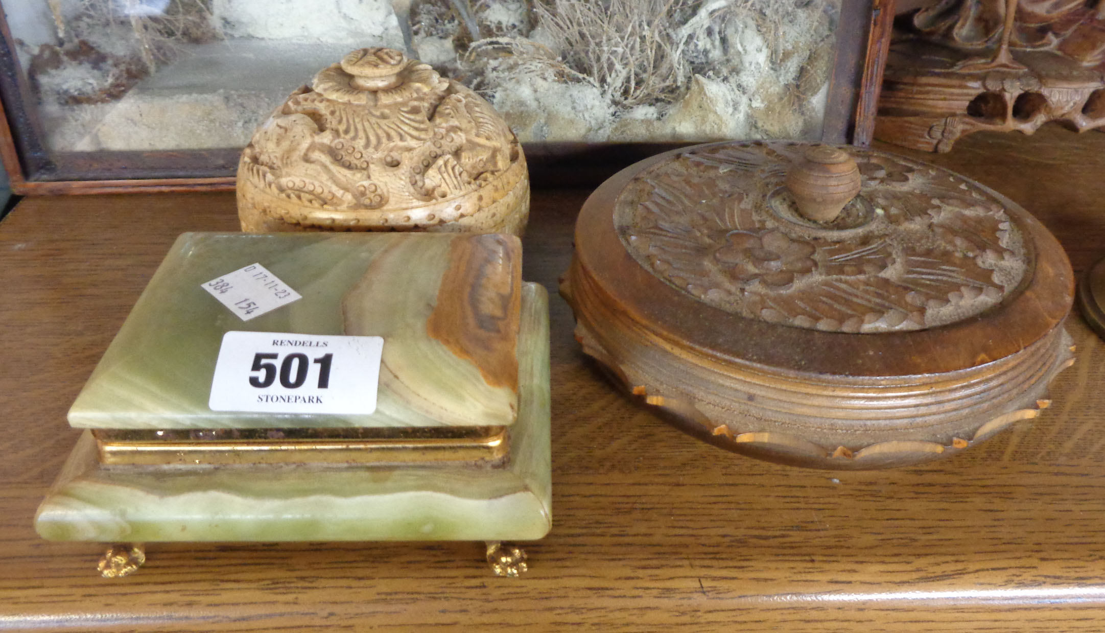 An old carved wooden circular box - sold with a vintage onyx cigarette box and a carved stone