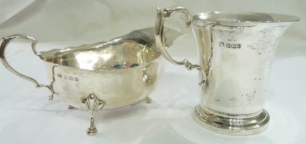 A silver flared rim mug with cast scroll handle and engraved initials - sold with a silver gravy