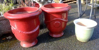 A pair of large red glazed ceramic plant pots - sold with a small ceramic plant pot