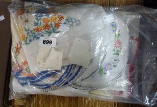 A bag containing a small quantity of embroidered table linen including place mats, tray cloths,