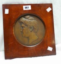 A Viennese bronze plaque depicting Dame Nellie Melba set in wooden frame with retailer's label to