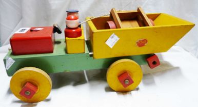 A vintage painted wood toy dumper truck and trailer with two wood figures