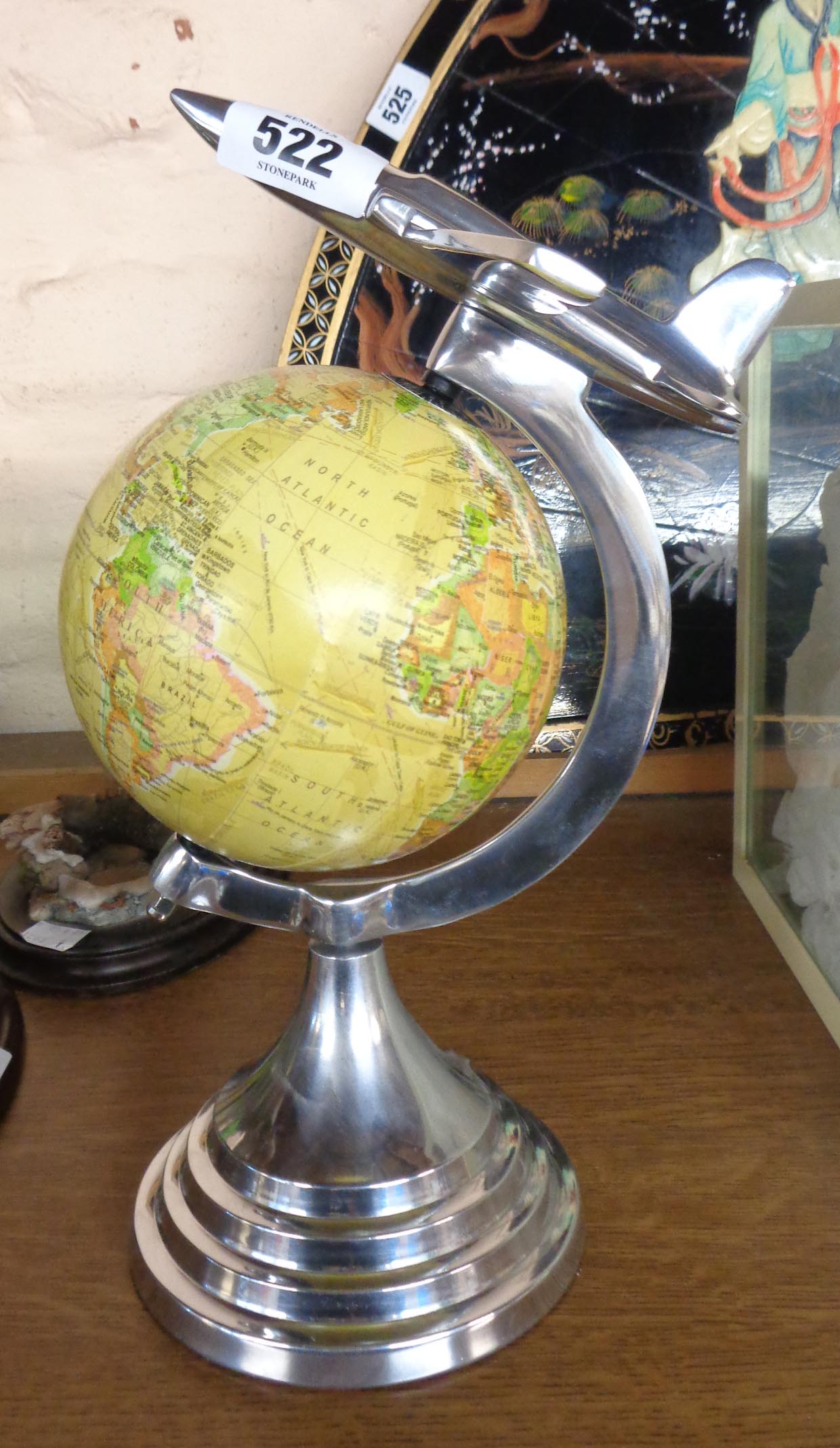 A modern globe with Art Deco style aeroplane stand