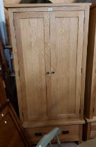 An 89cm modern light oak double wardrobe with hanging space enclosed by a pair of panelled doors