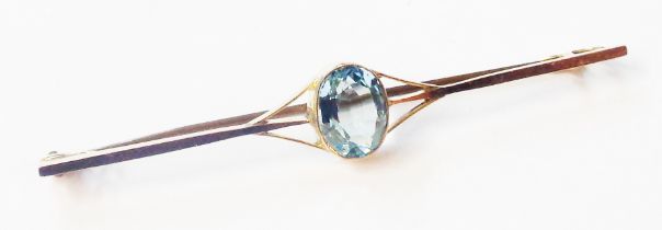 A marked 9ct. yellow metal bar brooch, set with central pale blue topaz stone