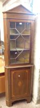 A 62cm Edwardian inlaid mahogany freestanding corner cabinet with shelves enclosed by an astragal