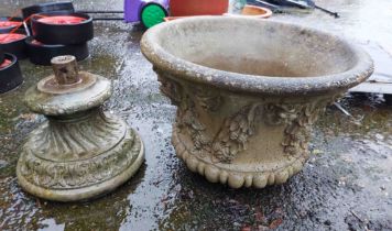 A large cast concrete planter of urn form with moulded decoration, set on a pedestal base