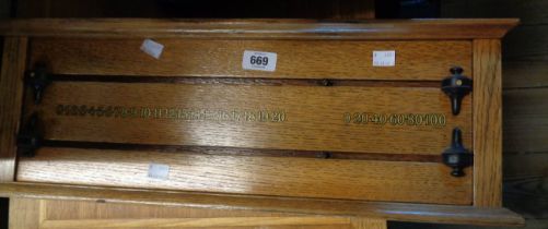 An old oak snooker score board with ebony markers