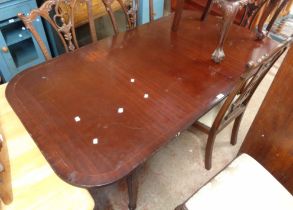 A 1.7m reproduction mahogany and strung dining table, set on reeded legs