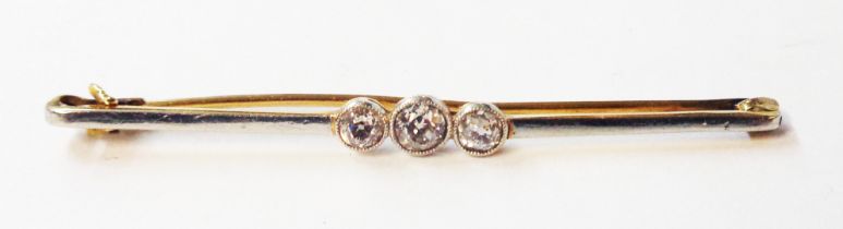 A yellow and white metal face three stone diamond bar brooch