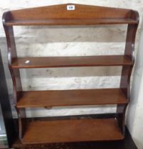 A 65cm Edwardian mahogany wall mounted four shelf open shelf unit with shaped sides