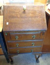 A 53cn vintage stained oak bureau with part fitted interior and three long drawers under