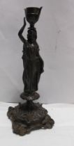 A 19th Century German bronze candlestick of classical maiden form - sold with a cast brass part desk