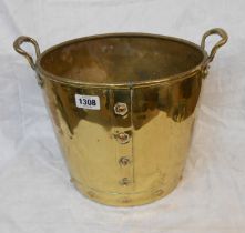 A brass coal bucket of riveted construction