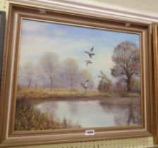 Royce Harmer: a parcel gilt framed oil on board, depicting ducks in flight over a pond - signed -