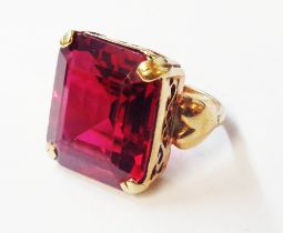 An unmarked yellow metal ring, set with large oblong ruby - size M 1/2 - boxed