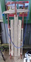 A vintage slatted wood and metal sled