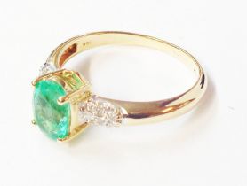 A 750 (18ct.) gold ring, set with central oval emerald with tiny diamonds to shoulders - size Q -