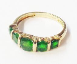 A 375 (9ct.) gold ring, set with five graduated green garnets - size L 1/2 - old box