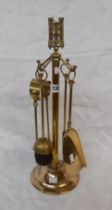 A brass companion set with castle finial