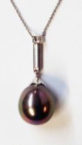 A high carat white metal drop pendant, set with large black pearl and small diamonds to suspender,