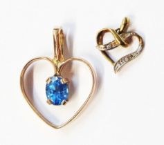 Two 9ct. gold heart shaped open pendants, one set with central oval Swiss blue topaz, the other