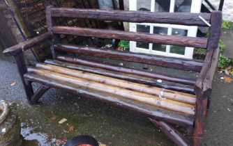 A 1.8m rustic garden bench constructed from reclaimed timbers